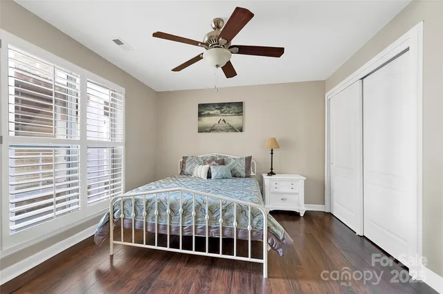 an aerial view of residential houses with outdoor space and lake view