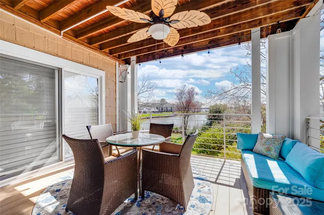a view of a dining room with furniture wooden floor and a potted plant