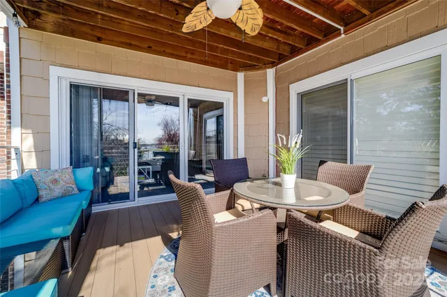 a view of a hallway with wooden floor and a bathroom