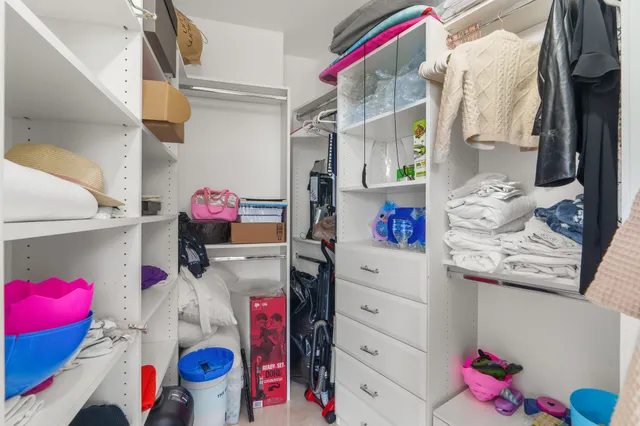 a bedroom with a bed a dresser and a window