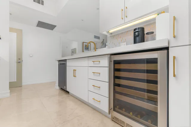 a view of a kitchen with cabinets and a ceiling fan