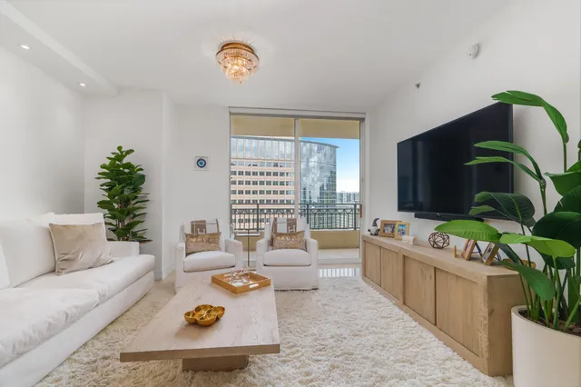 a living room with furniture and a potted plant