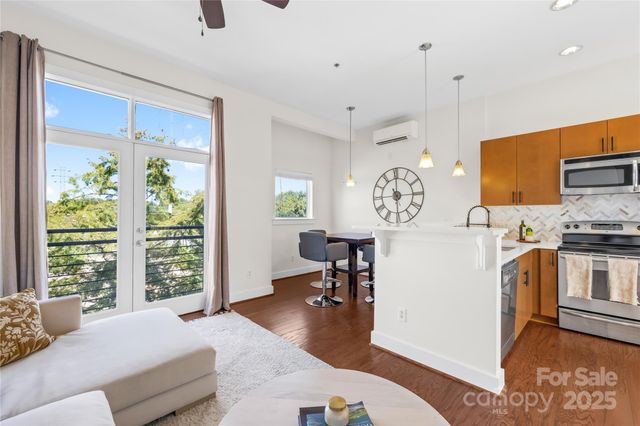 a spacious bedroom with a bed a dresser and next to a window