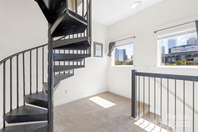 a view of staircase with white walls and a window