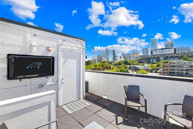 a view of a chairs and table in a balcony