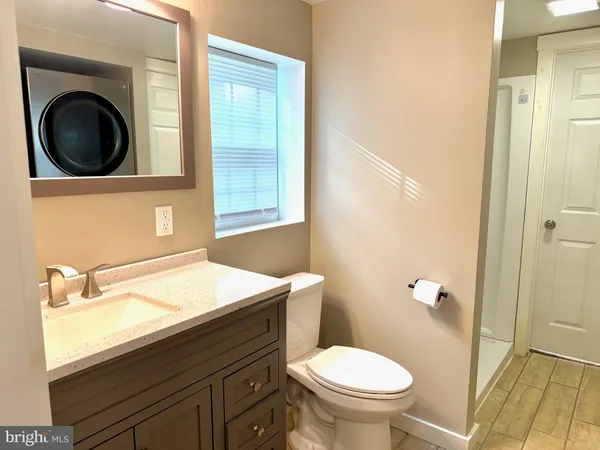 a bathroom with a toilet a sink and a mirror