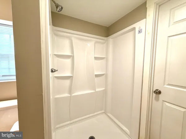 a bathroom with a bathtub and shower