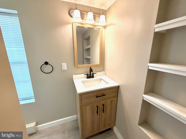 a bathroom with a sink a toilet and mirror