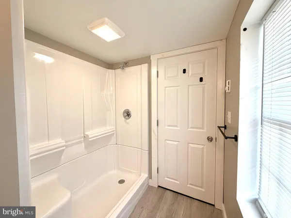 a bathroom with a bathtub and a shower