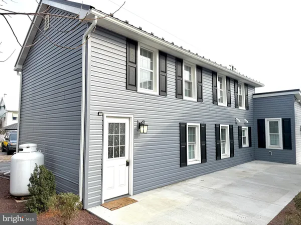 a front view of a house with white walls
