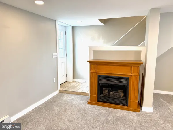 a view of an empty room with a fireplace