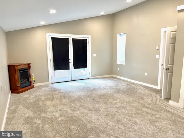 a view of an empty room with a fireplace