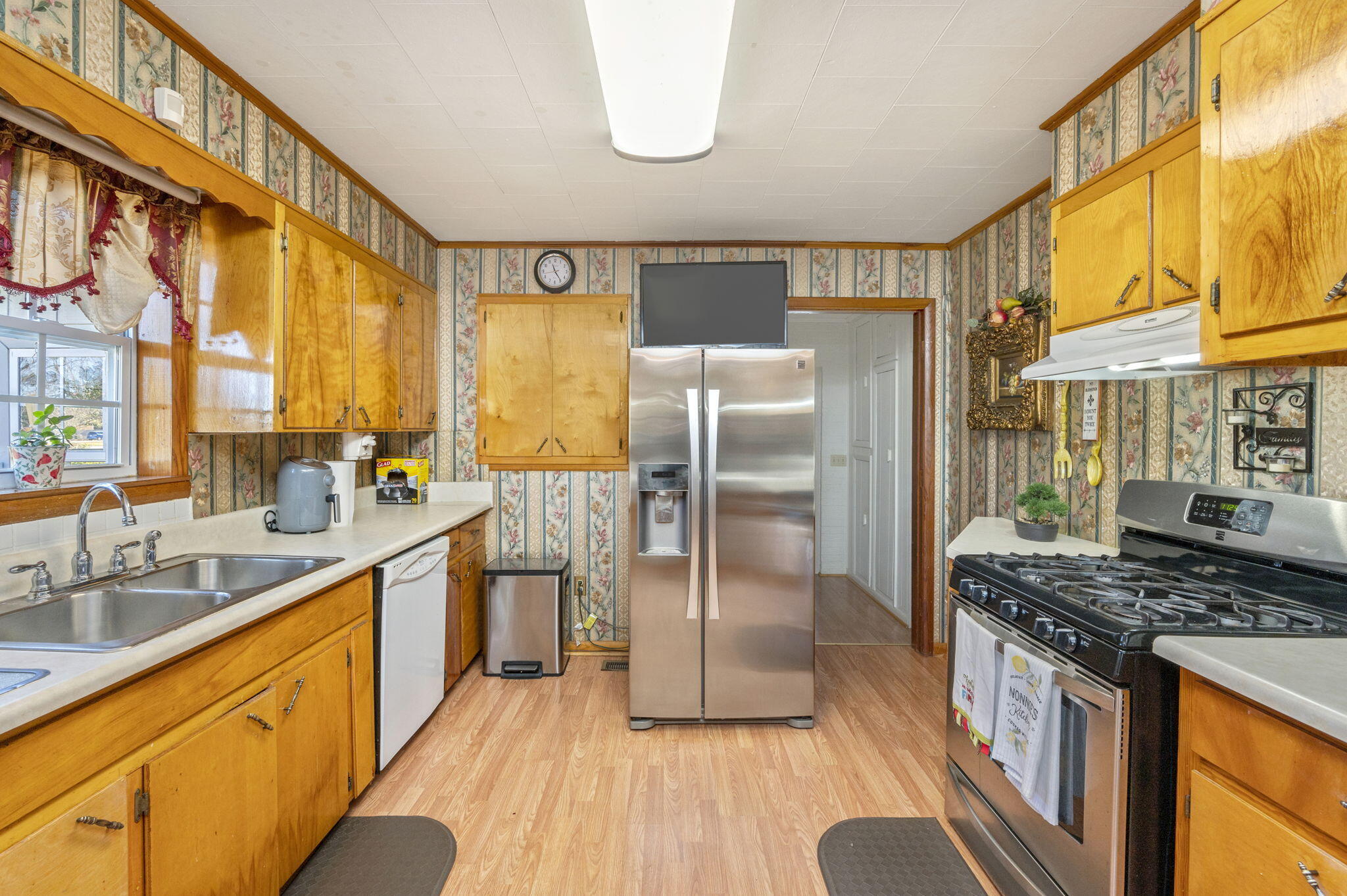 5303 Griffith Mill Road Baker, FL 32531 - Photo 12 of 58 a kitchen with stainless steel appliances granite countertop a refrigerator a sink dishwasher a stove and a dining table with wooden floor