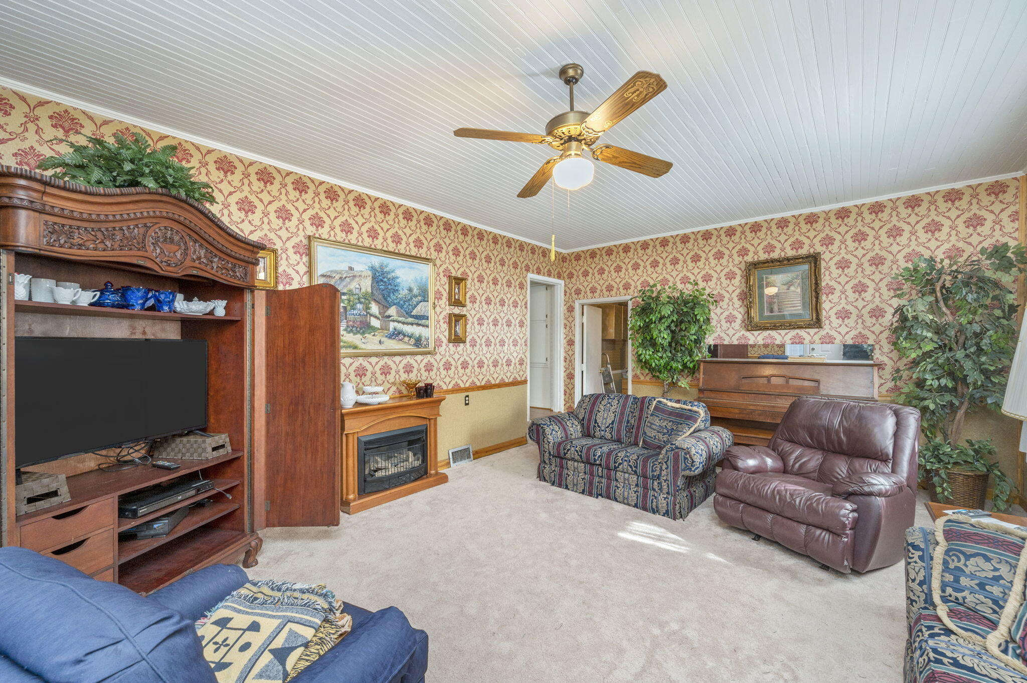 5303 Griffith Mill Road Baker, FL 32531 - Photo 16 of 58 a living room with furniture a flat screen tv and a fireplace