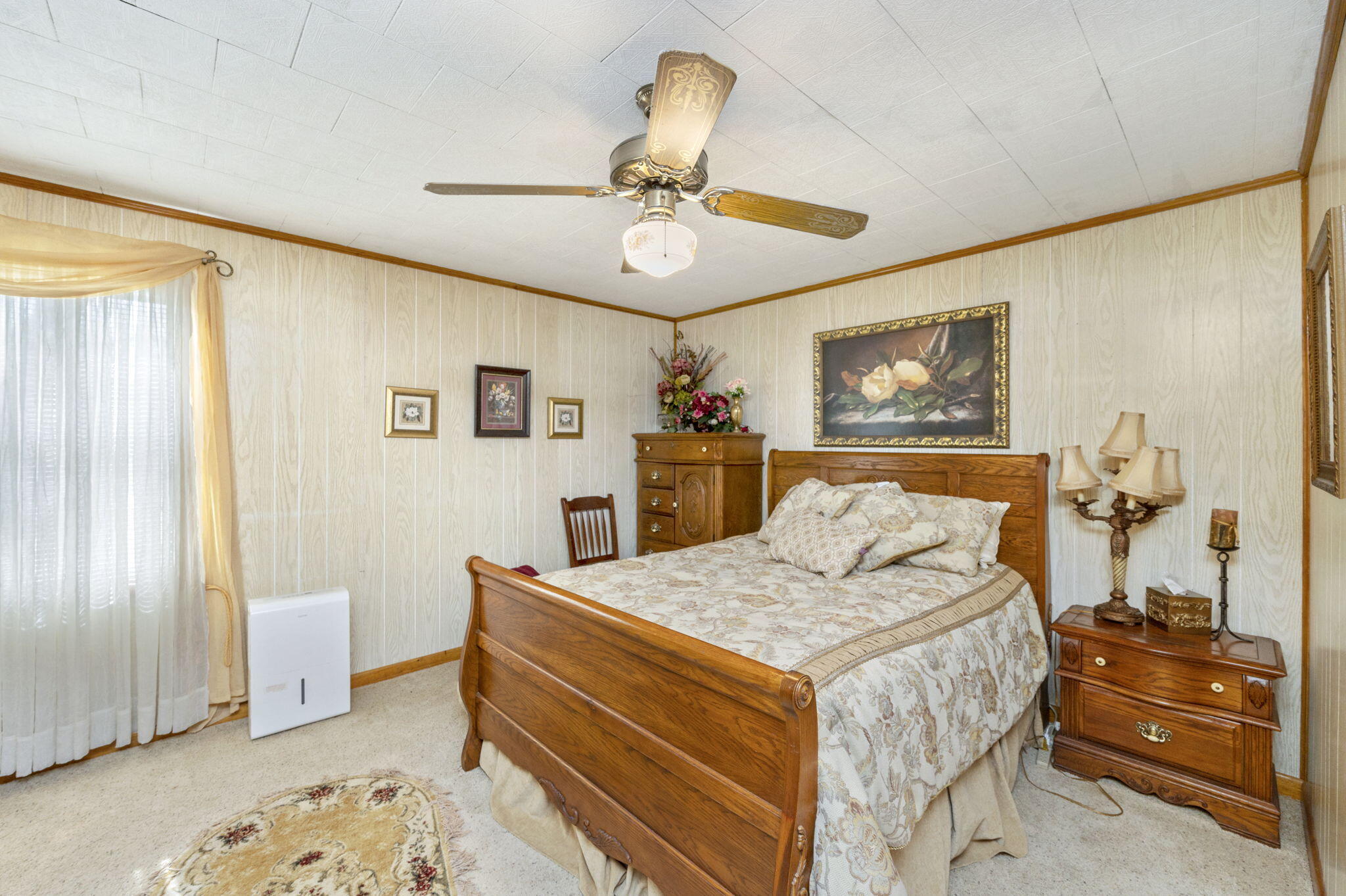 5303 Griffith Mill Road Baker, FL 32531 - Photo 19 of 58 a bedroom with a bed and a chandelier