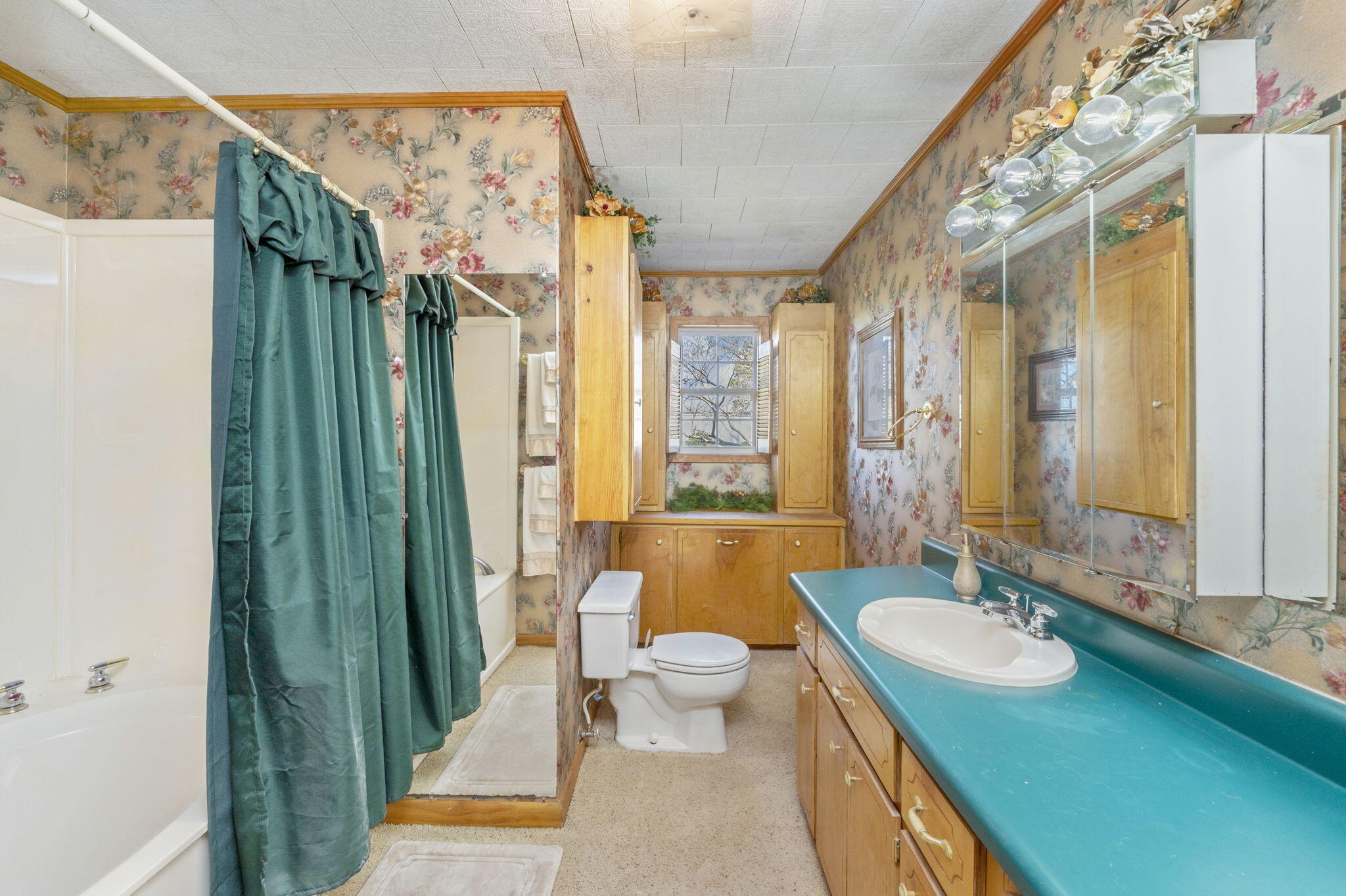 5303 Griffith Mill Road Baker, FL 32531 - Photo 20 of 58 a spacious bathroom with a granite countertop sink a toilet a mirror and shower