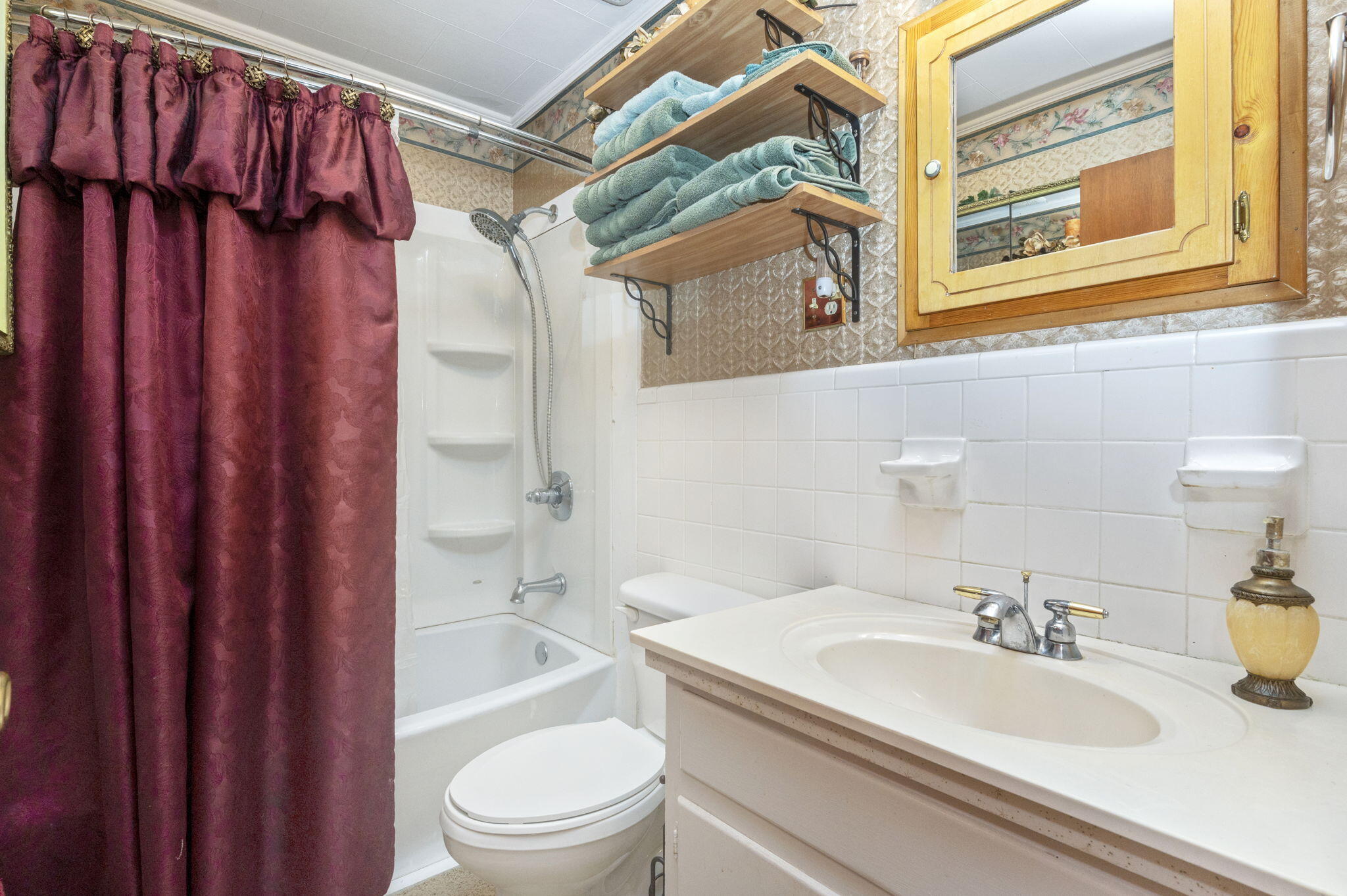 5303 Griffith Mill Road Baker, FL 32531 - Photo 22 of 58 a bathroom with a granite countertop sink toilet and shower
