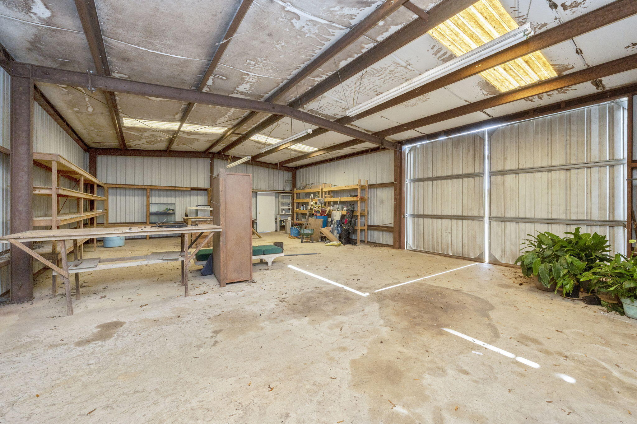 5303 Griffith Mill Road Baker, FL 32531 - Photo 38 of 58 a view of a garage with wooden floor