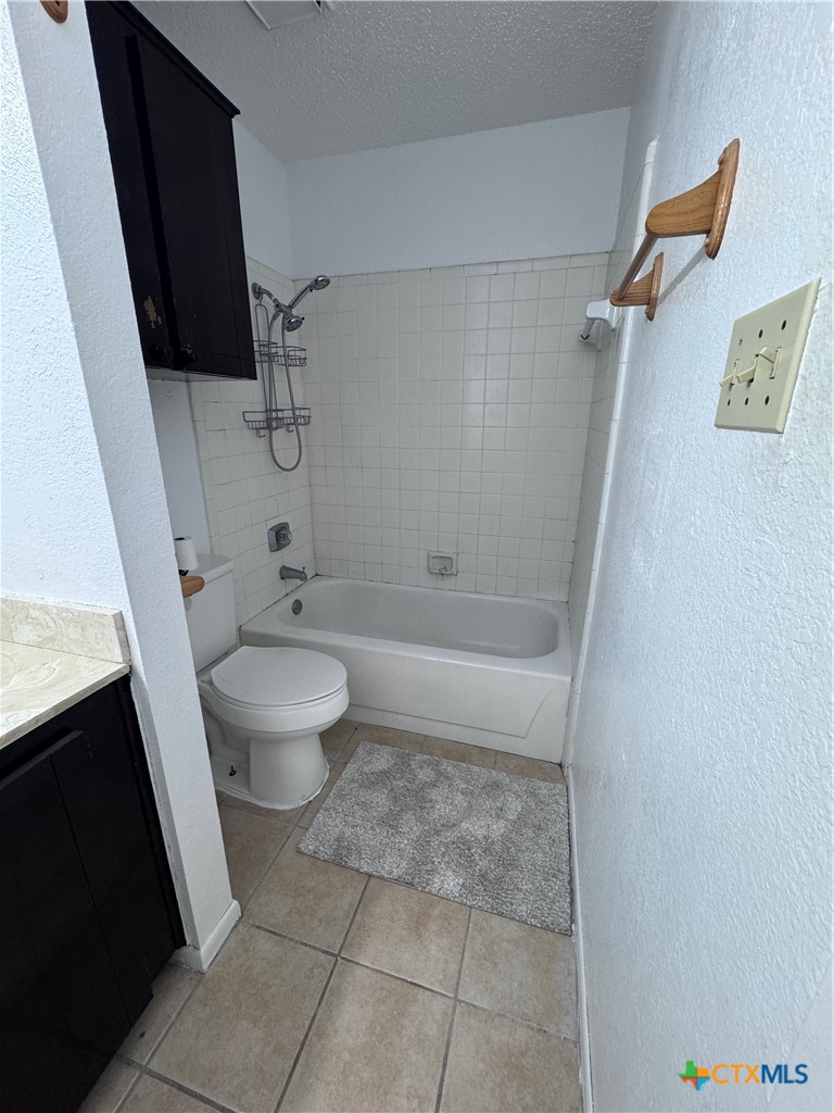 1301 North 10th Street Temple, TX 76501 - Photo 14 of 25 a bathroom with a granite countertop sink toilet and shower