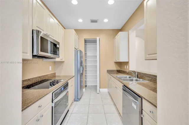 a kitchen with stainless steel appliances granite countertop a stove and a sink