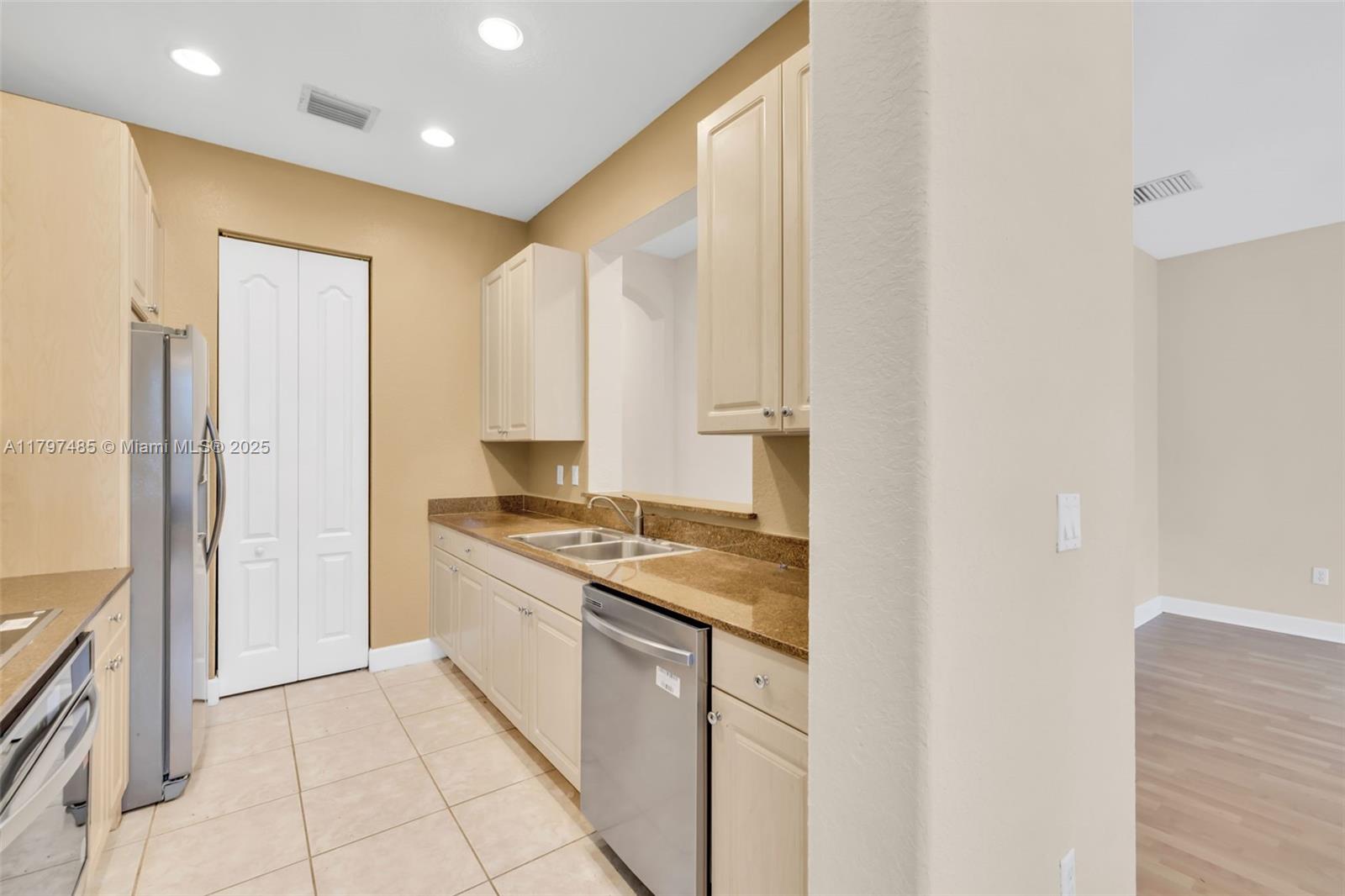 8706 Blaze Court Davie, FL 33328 - Photo 12 of 44 a kitchen with stainless steel appliances granite countertop a refrigerator and a stove top oven