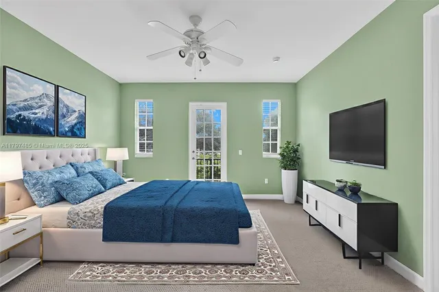 a bedroom with a large bed and a flat screen tv