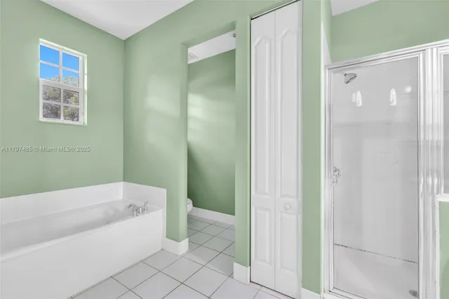 a bathroom with a bathtub and shower