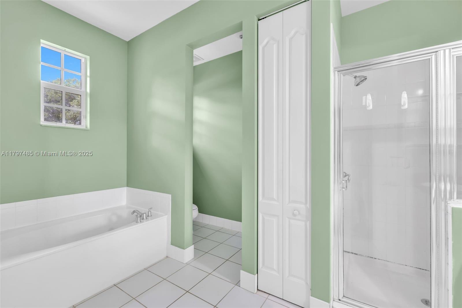 8706 Blaze Court Davie, FL 33328 - Photo 20 of 44 a bathroom with a bathtub and shower