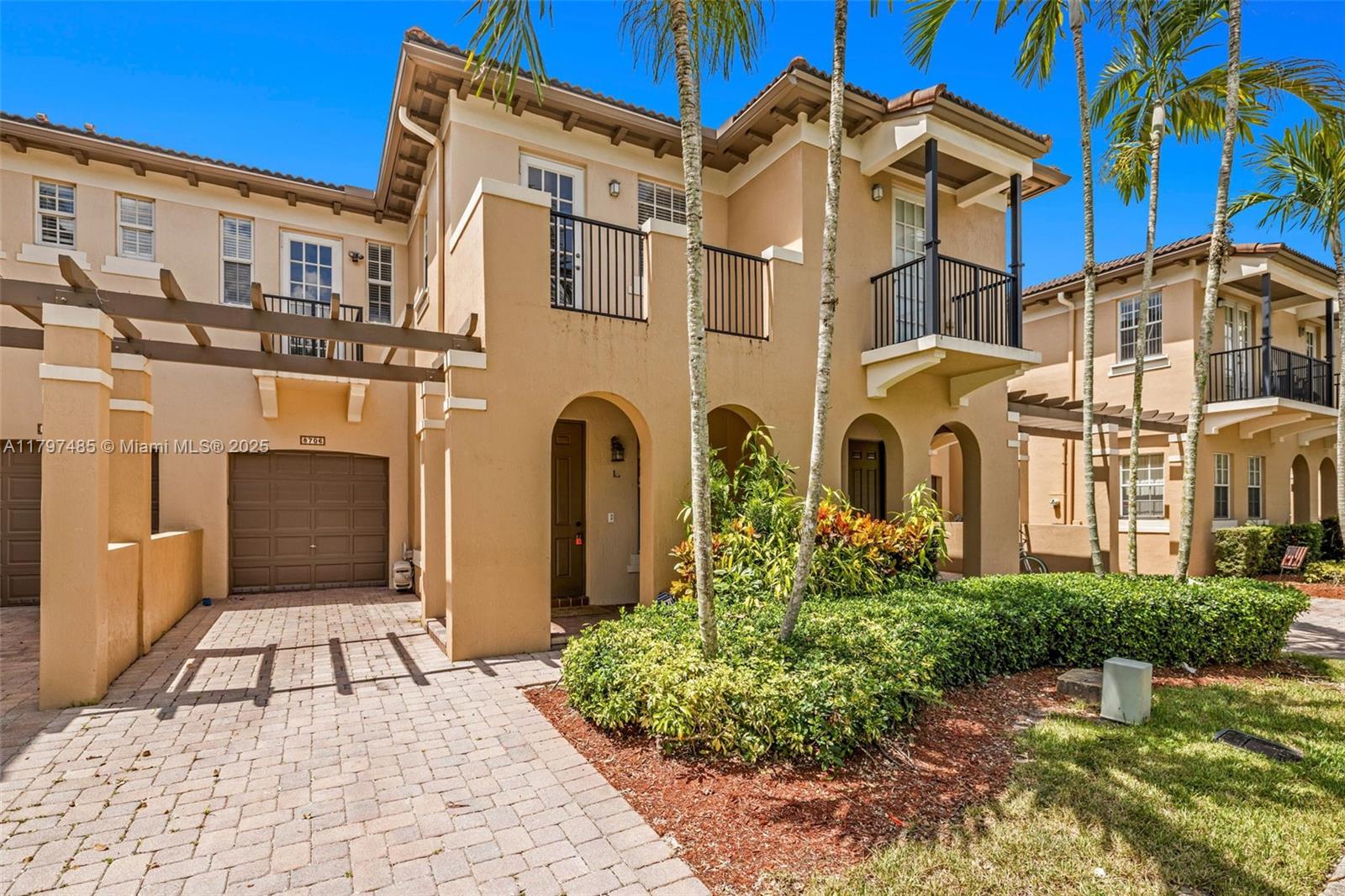 8706 Blaze Court Davie, FL 33328 - Photo 2 of 44 a view of a blue building with many windows