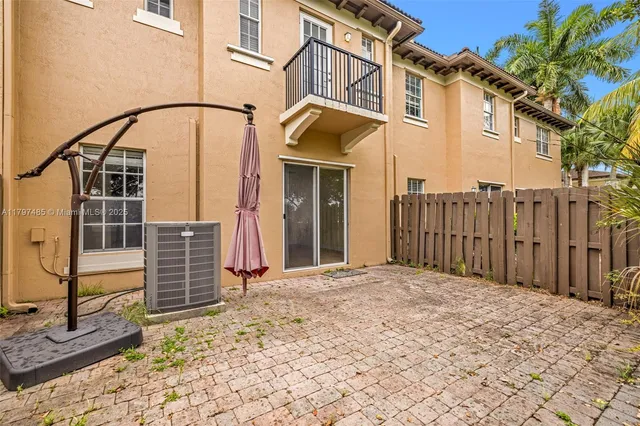 a view of a house with a wooden fence