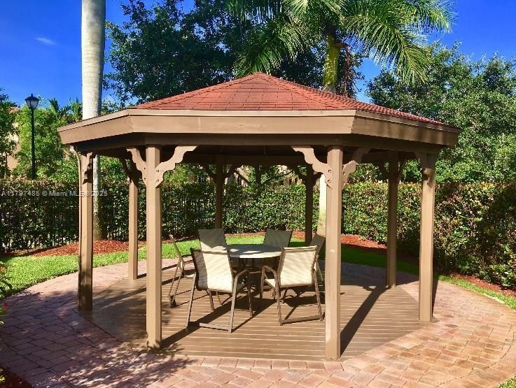 8706 Blaze Court Davie, FL 33328 - Photo 36 of 44 a patio with table and chairs