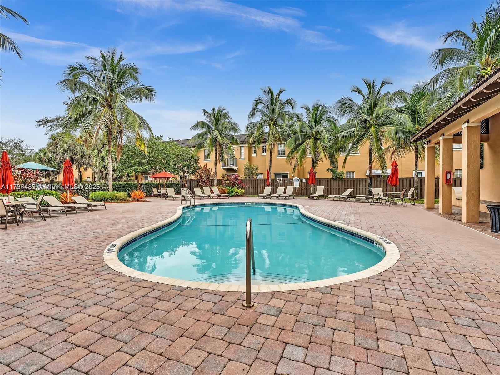 8706 Blaze Court Davie, FL 33328 - Photo 38 of 44 a swimming pool with outdoor seating and yard