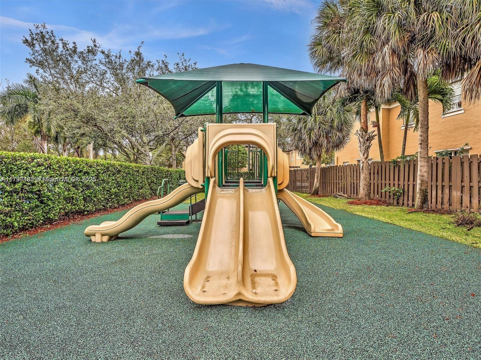 8706 Blaze Court Davie, FL 33328 - Photo 40 of 44 a view of a swimming pool with a garden