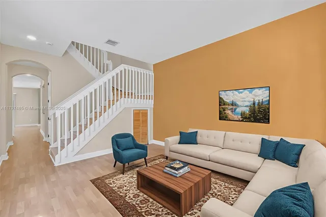 a living room with furniture and a rug