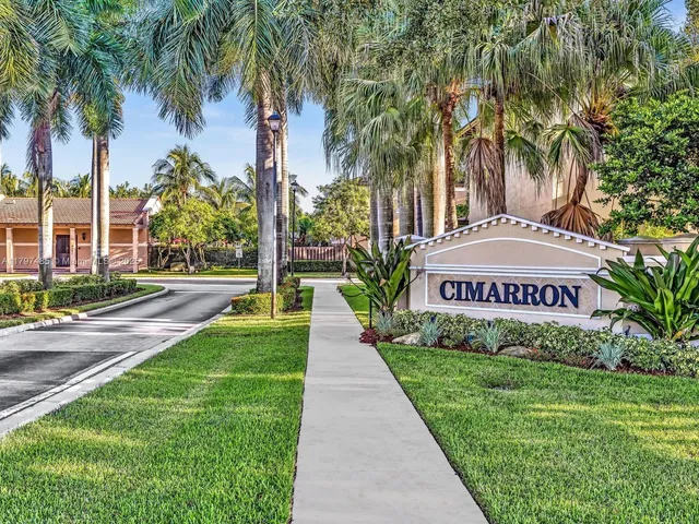 a view of swimming pool with outdoor seating and palm trees