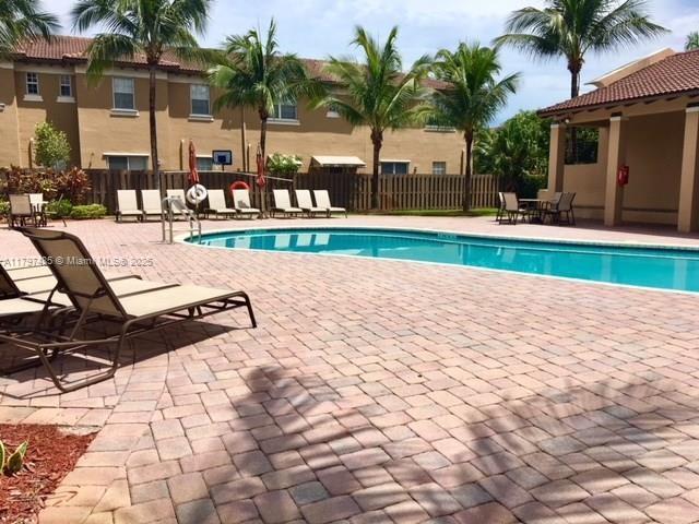 8706 Blaze Court Davie, FL 33328 - Photo 44 of 44 a view of swimming pool with outdoor seating and palm trees