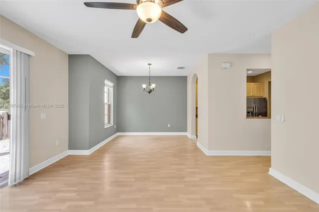 a view of a big room with wooden floor and windows in a room