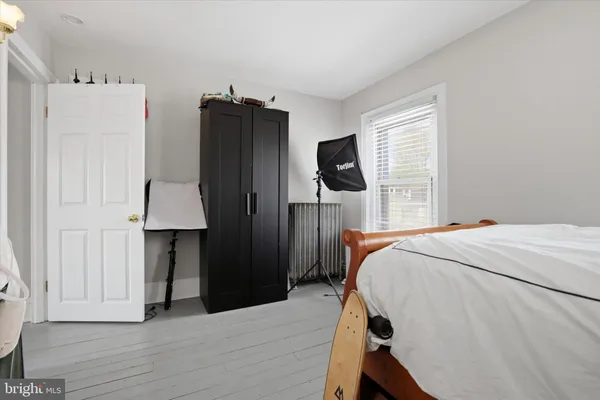a bed room with a bed and a flat tv screen