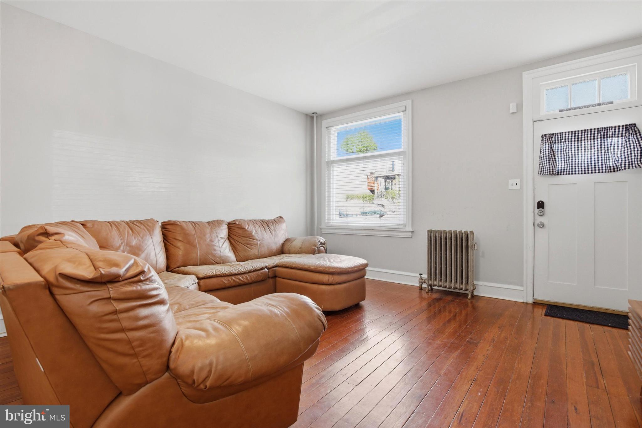343 Spring Mill Avenue Conshohocken, PA 19428 - Photo 3 of 24 a living room with furniture a wooden floor and a window