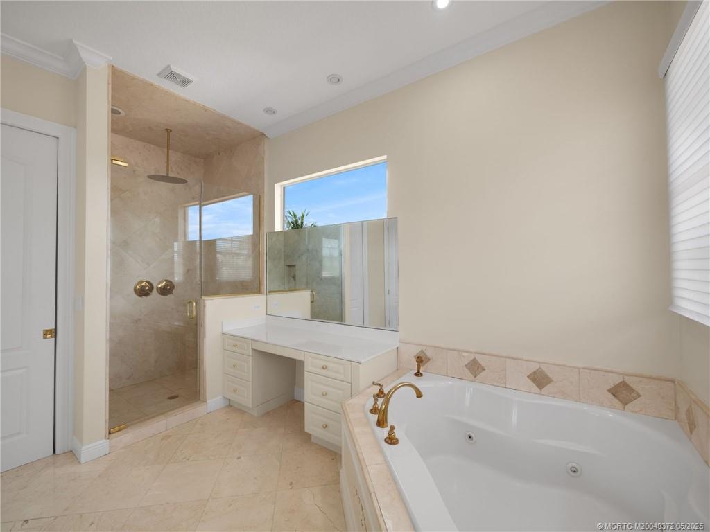 6 West High Point Road Stuart, FL 34996 - Photo 20 of 54 a bathroom with a bathtub and a shower