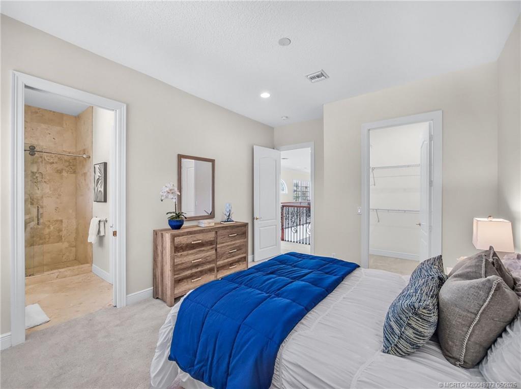 6 West High Point Road Stuart, FL 34996 - Photo 25 of 54 a bedroom with a bed and a couch