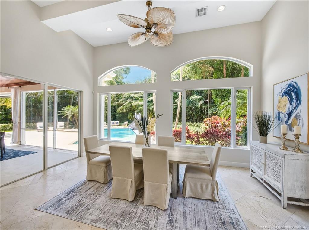 6 West High Point Road Stuart, FL 34996 - Photo 10 of 54 a dining room with furniture a chandelier and a rug