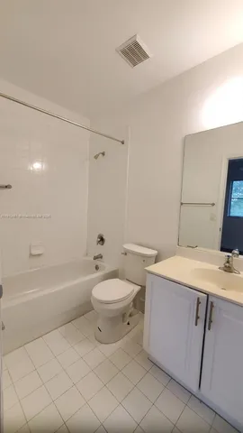 a view of a hallway with a bathroom