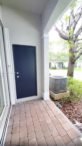 a view of a lake with a yard and large trees
