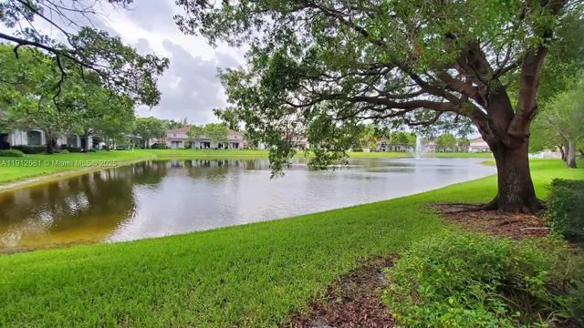 a view of a lake with a building and trees around