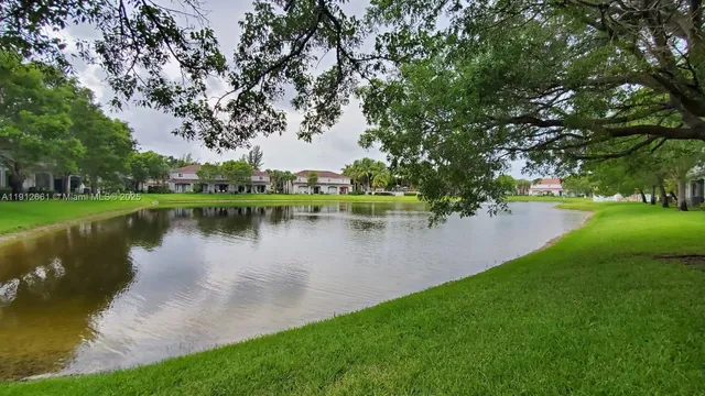 a swimming pool with outdoor seating and a garden