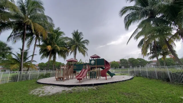 a front view of a house with garden and trees