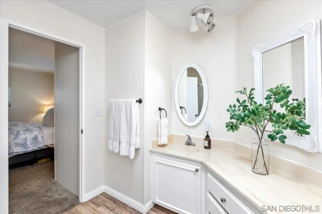 a bathroom with a granite countertop sink and a mirror