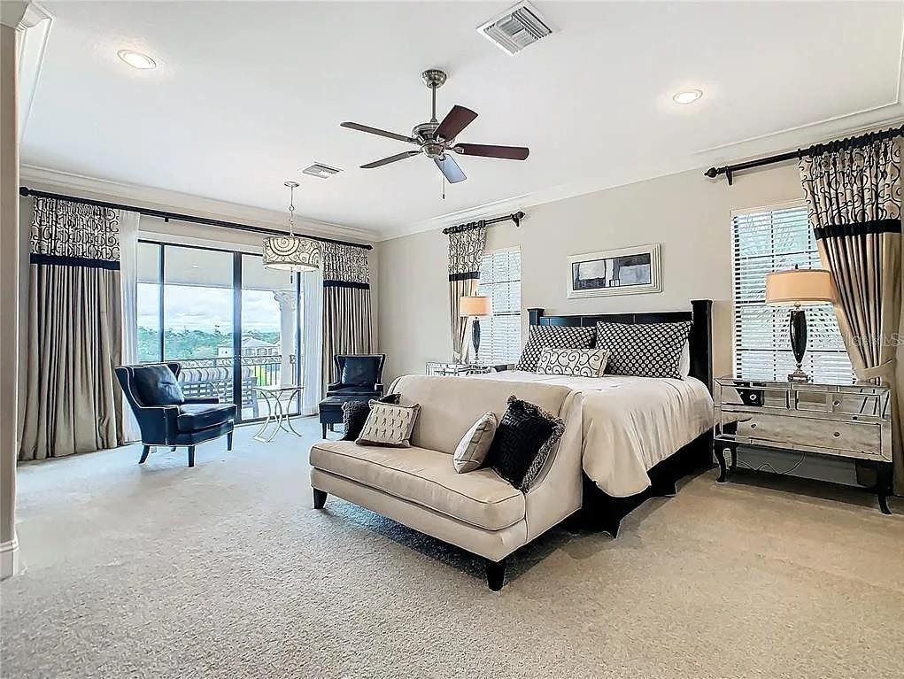 395 Muirfield Loop Reunion, FL 34747 - Photo 19 of 50 a bedroom with bed and large window