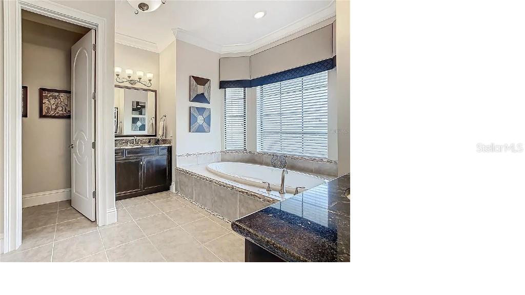 395 Muirfield Loop Reunion, FL 34747 - Photo 20 of 50 a living room with furniture and a refrigerator